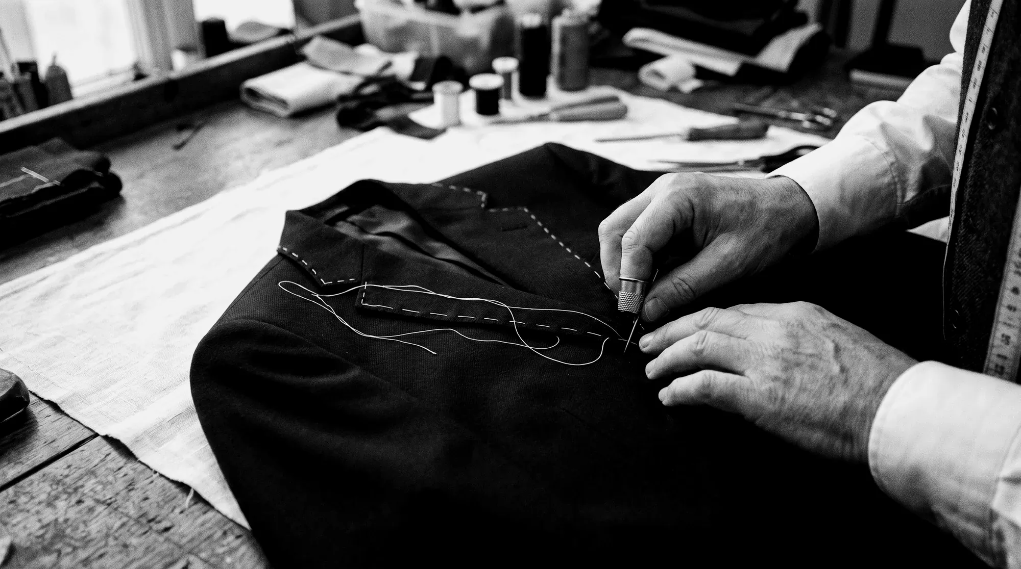 Tailor stitching a jacket front