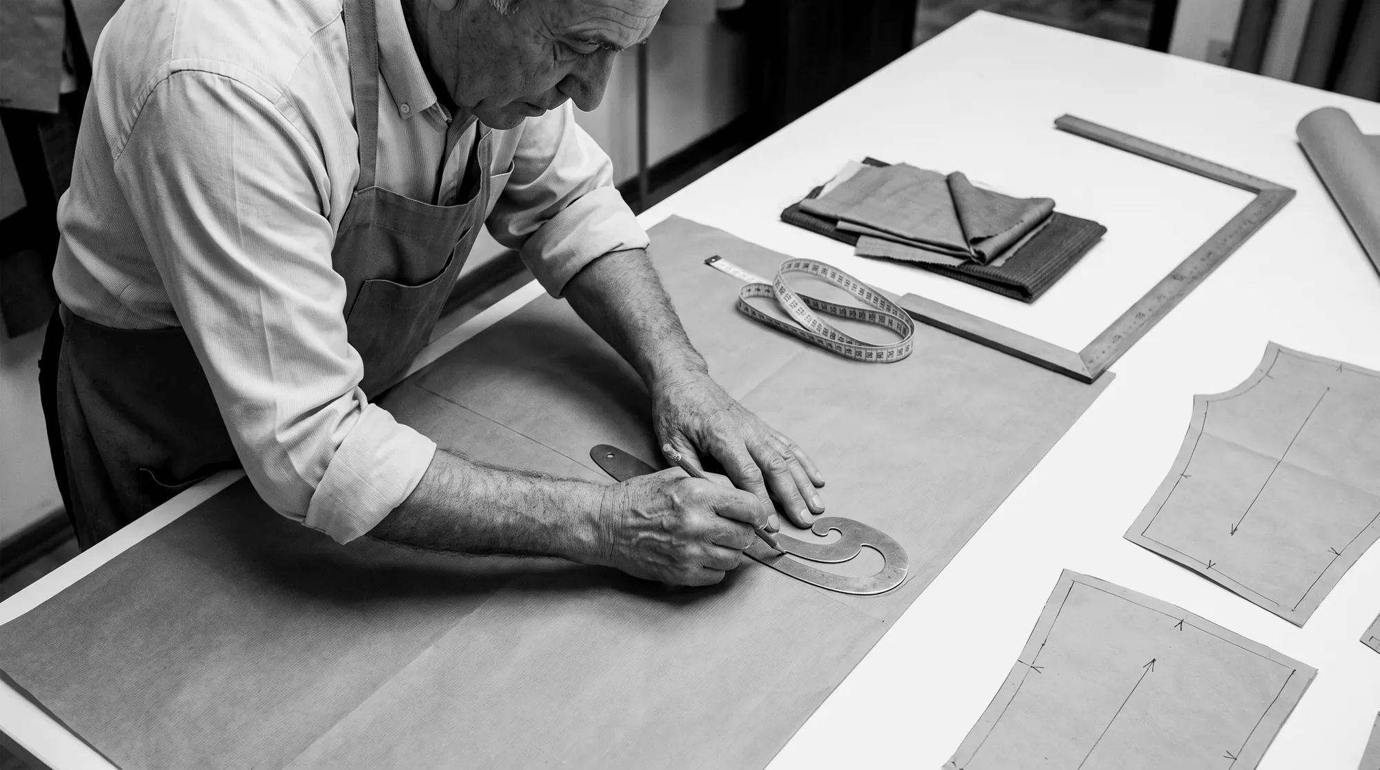Tailor drawing a pattern in chalk on wool